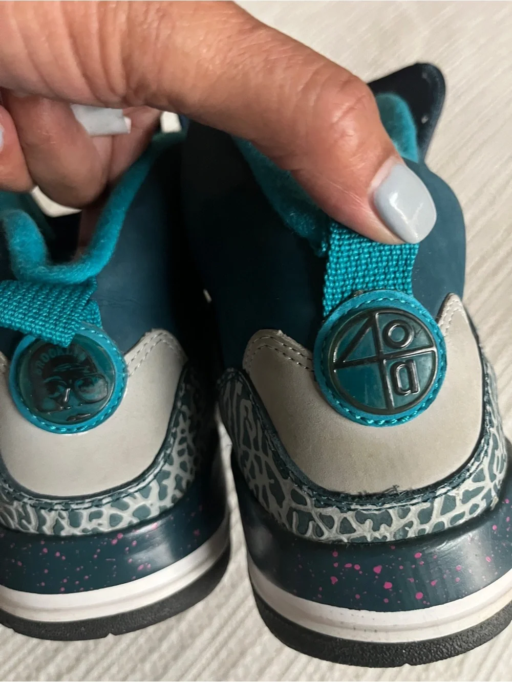 Jordan Spizike Space Teal and Gray Sneakers with Pink Accent.